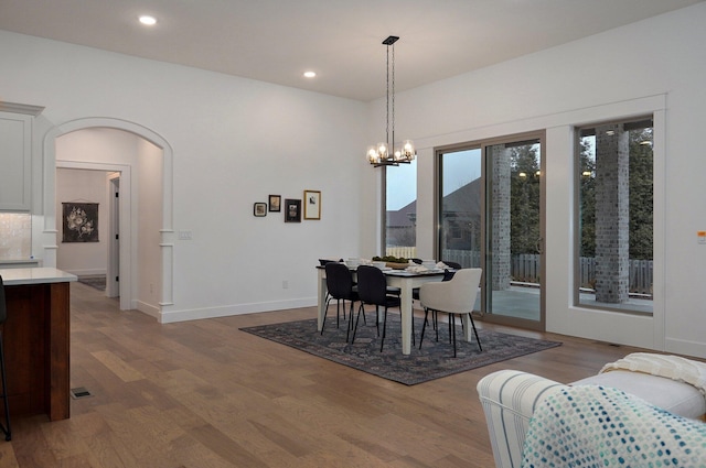 dining room with wood-type flooring and a chandelier