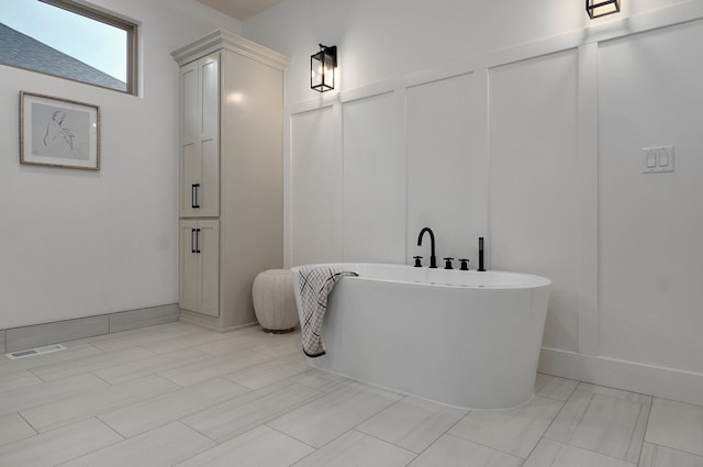 bathroom with a tub to relax in