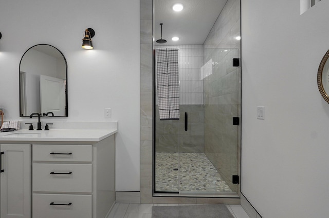 bathroom featuring vanity and a shower with shower door