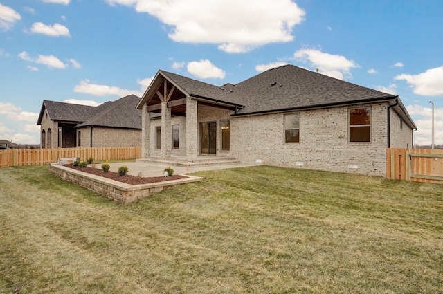 back of house with a yard and a patio area