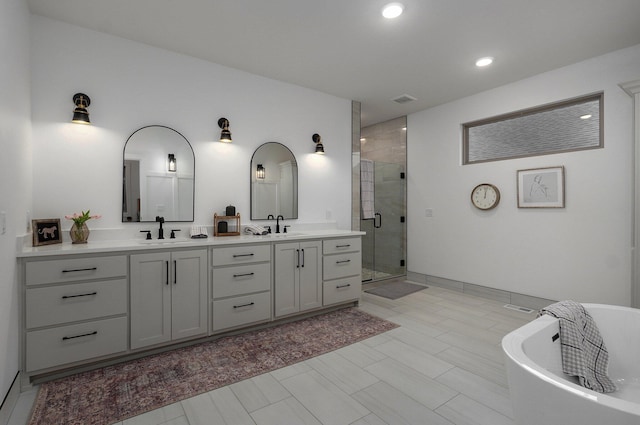 bathroom with independent shower and bath and vanity