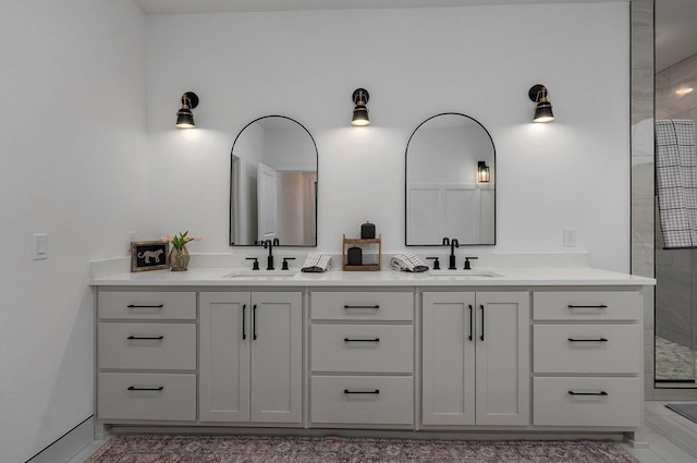 bathroom with vanity and a shower with shower door