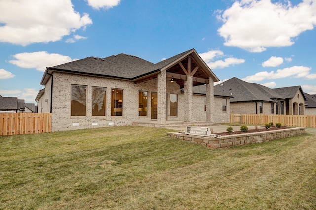 back of property featuring a patio area and a lawn