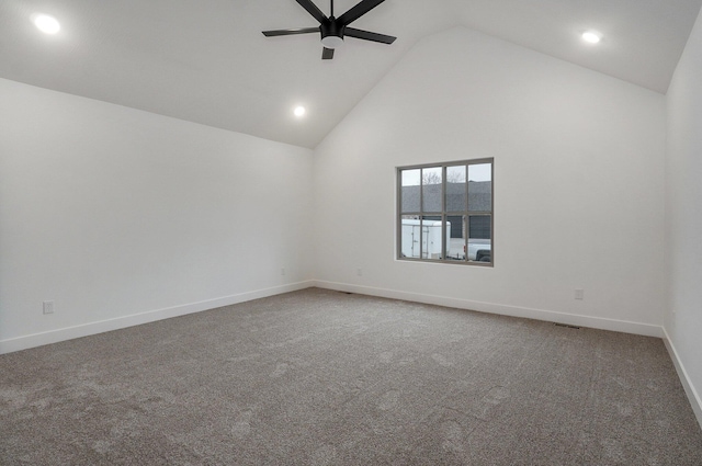 unfurnished room featuring dark carpet, high vaulted ceiling, and ceiling fan