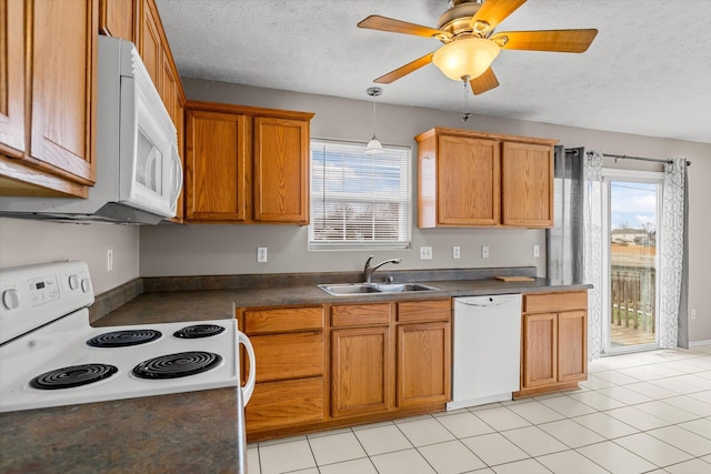 kitchen with light tile patterned flooring, sink, a textured ceiling, pendant lighting, and white appliances