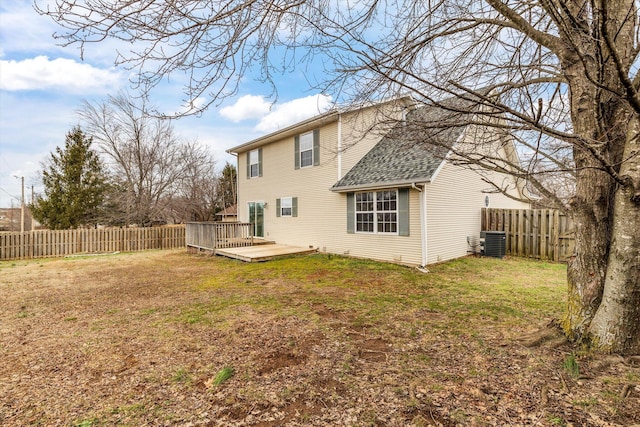 back of house with a wooden deck, central AC unit, and a lawn