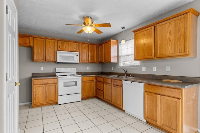 kitchen with light tile patterned flooring, sink, white appliances, hanging light fixtures, and ceiling fan