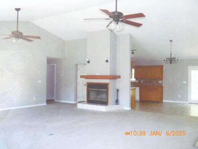 unfurnished living room featuring ceiling fan and high vaulted ceiling