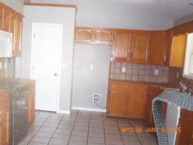 kitchen featuring tile patterned flooring and decorative backsplash