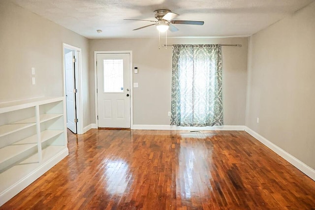 foyer entrance featuring ceiling fan, hardwood / wood-style floors, a textured ceiling, and a wealth of natural light