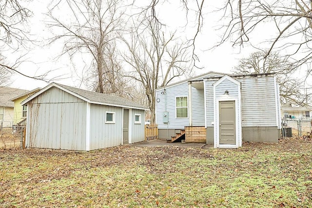 rear view of property featuring an outbuilding