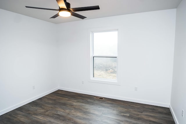 empty room featuring ceiling fan and dark hardwood / wood-style flooring