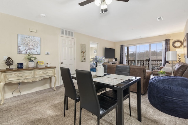 dining space featuring light carpet