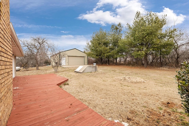 view of yard featuring an outbuilding, a garage, and a deck