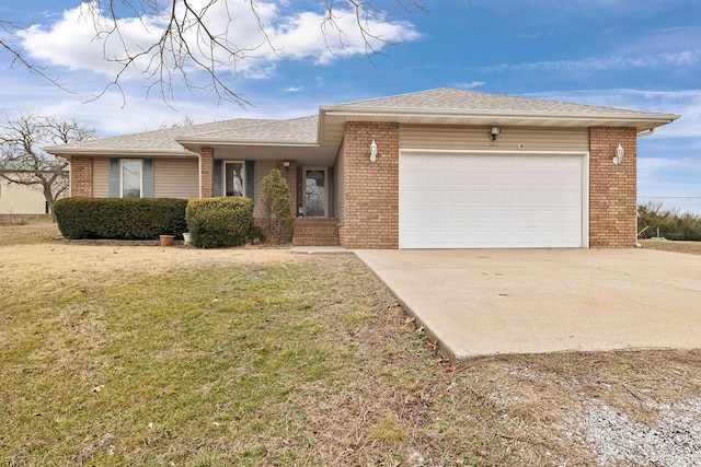 view of front of property featuring a garage and a front lawn