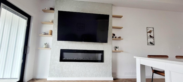 living room with a wealth of natural light and a fireplace