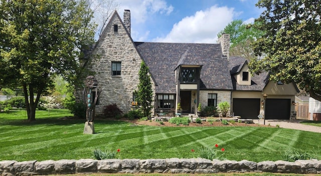 view of front facade with a garage and a front lawn