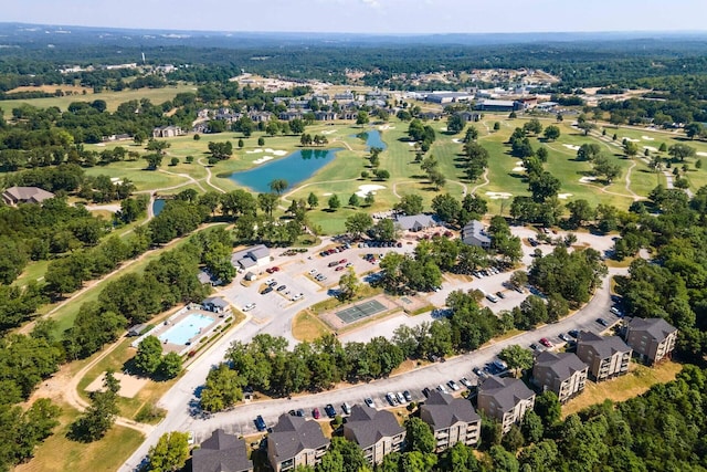 aerial view featuring a residential view, golf course view, and a water view