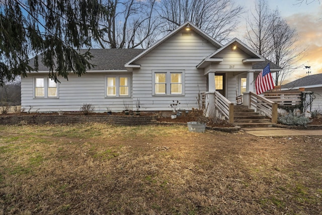 view of front of property featuring a yard and covered porch