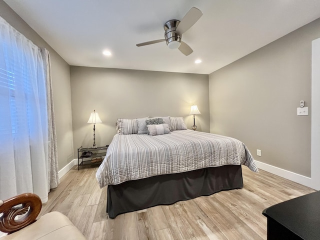 bedroom with light hardwood / wood-style floors and ceiling fan