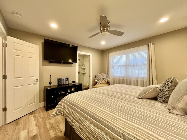 bedroom featuring ceiling fan, ensuite bathroom, and light hardwood / wood-style floors