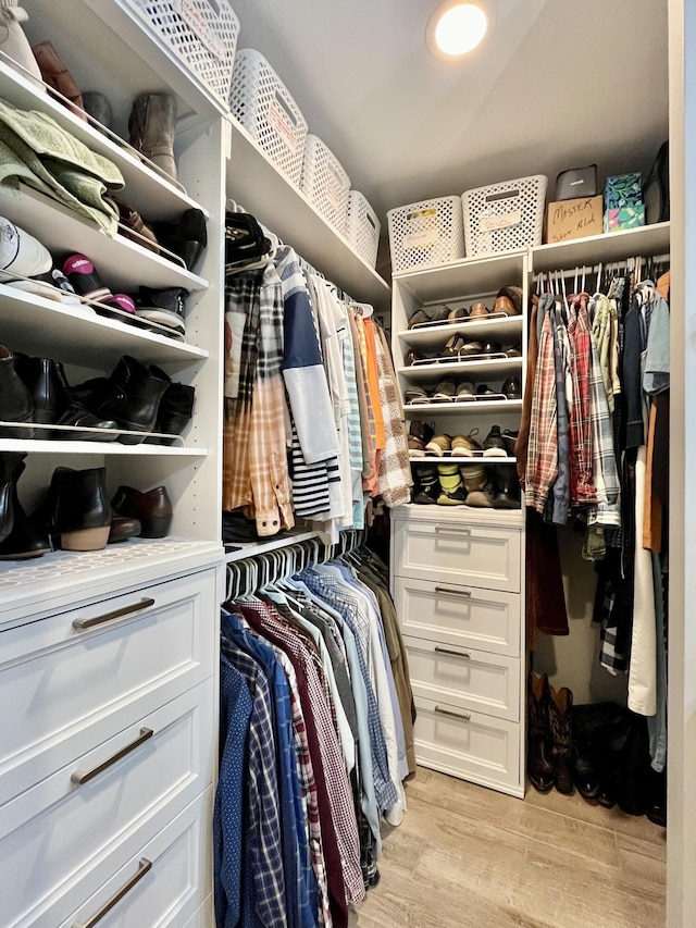 walk in closet featuring light hardwood / wood-style flooring