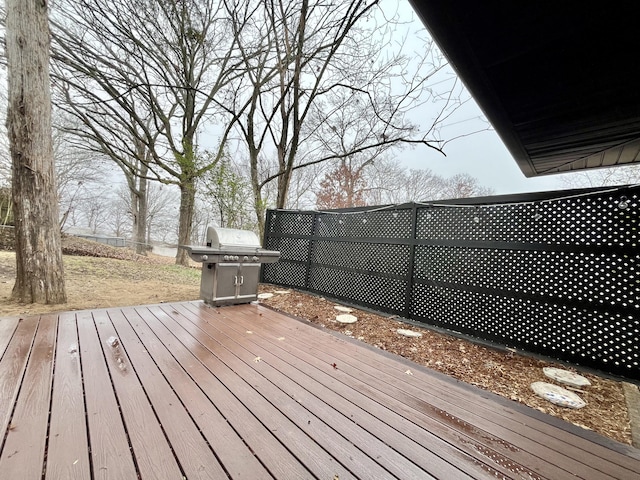 wooden terrace featuring a grill