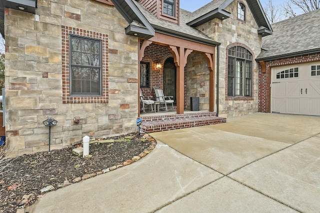 entrance to property featuring a porch and a garage