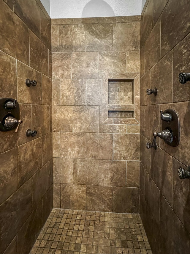 bathroom with tiled shower