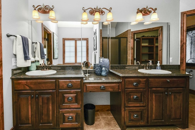 bathroom featuring a shower with door, vanity, and tile patterned flooring