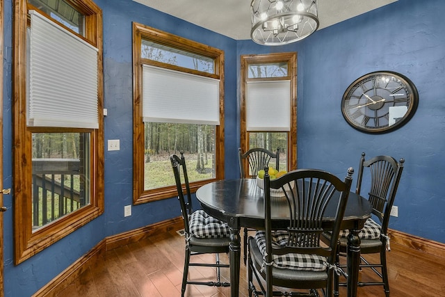 dining room featuring an inviting chandelier and dark hardwood / wood-style flooring