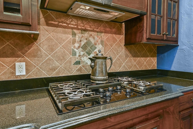 kitchen with decorative backsplash, black gas stovetop, and ventilation hood