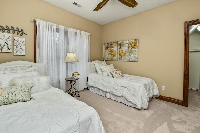 carpeted bedroom featuring lofted ceiling and ceiling fan