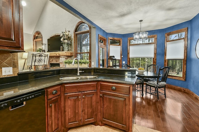 kitchen with sink, wood-type flooring, dishwasher, a notable chandelier, and pendant lighting