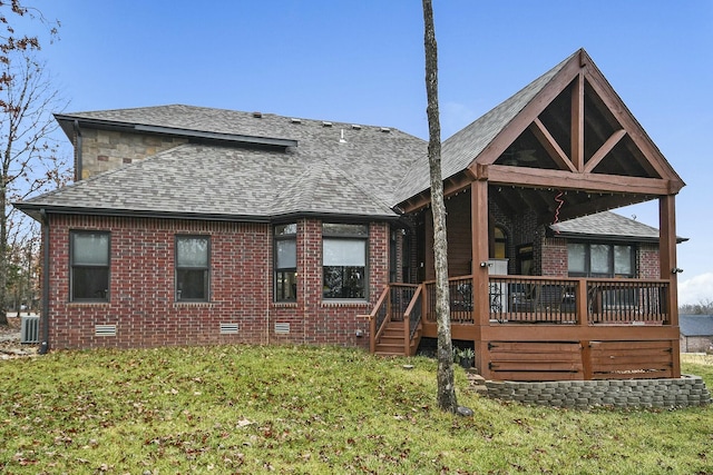 back of property featuring a yard, central AC, and a deck