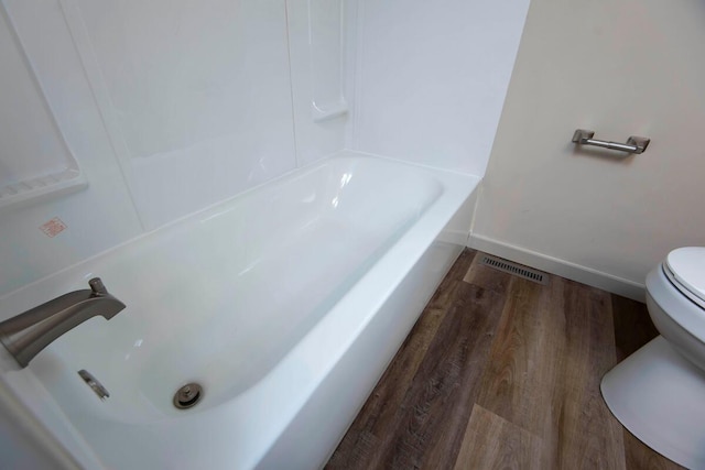 bathroom with wood-type flooring and toilet