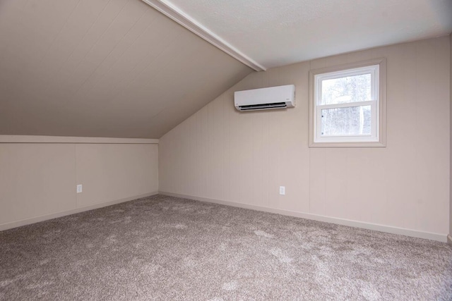 additional living space featuring lofted ceiling, a textured ceiling, a wall mounted AC, and carpet