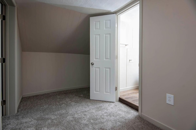 bonus room with lofted ceiling and carpet floors