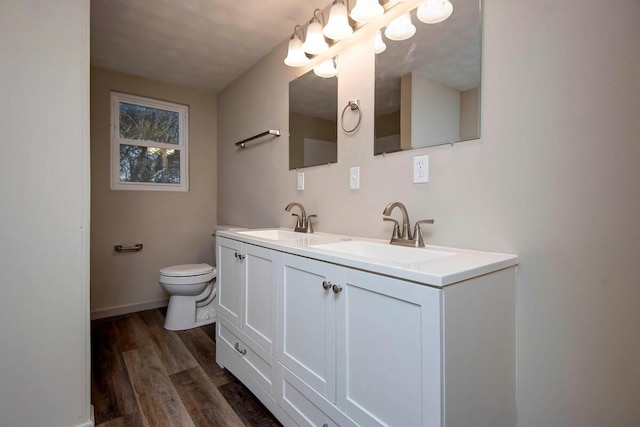 bathroom featuring vanity, hardwood / wood-style flooring, and toilet