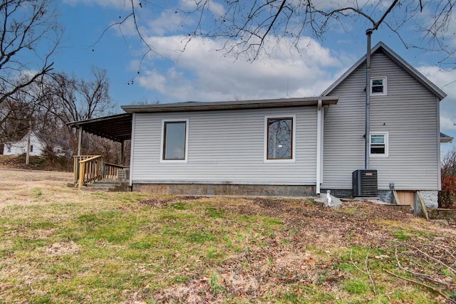 back of property featuring central AC, a lawn, and a porch