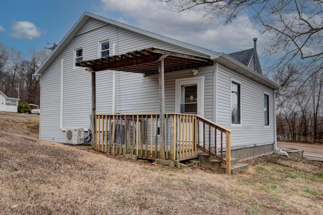 exterior space featuring ac unit and a lawn