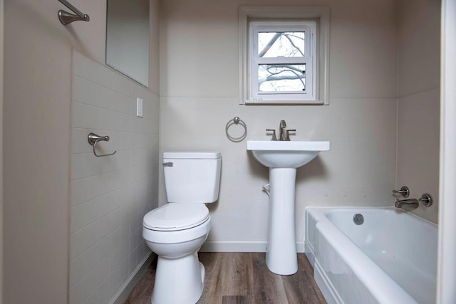 bathroom featuring toilet, hardwood / wood-style floors, and tile walls