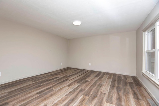 empty room with dark wood-type flooring