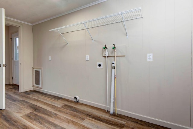 clothes washing area with electric dryer hookup, washer hookup, wood-type flooring, and ornamental molding