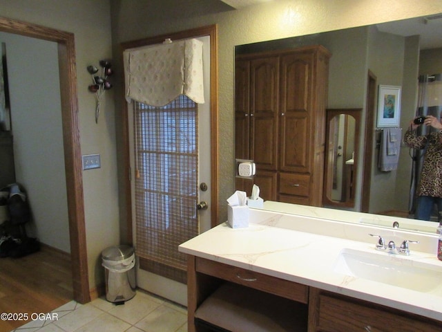 bathroom featuring tile patterned flooring and vanity