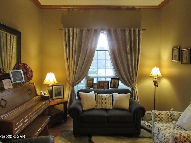 sitting room with crown molding and hardwood / wood-style floors