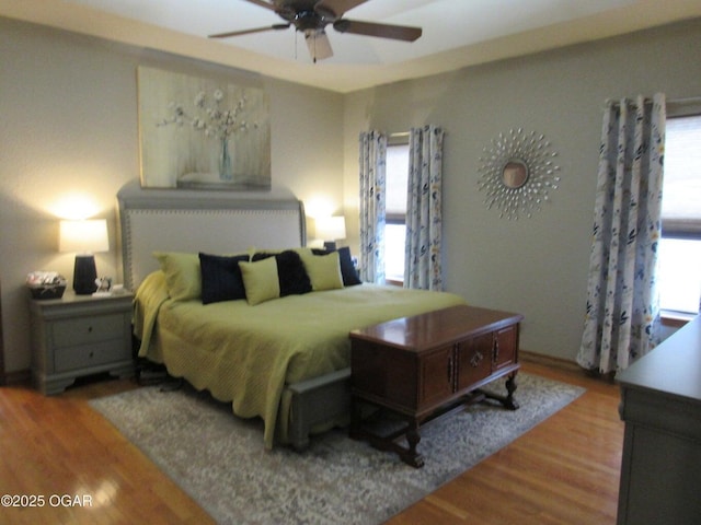 bedroom with ceiling fan and wood-type flooring