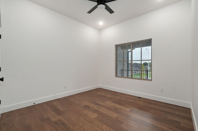 empty room featuring dark wood-type flooring and ceiling fan