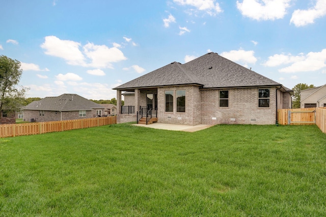 back of house with a patio and a lawn