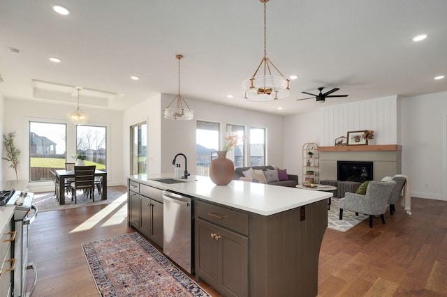 kitchen featuring pendant lighting, sink, an island with sink, and appliances with stainless steel finishes